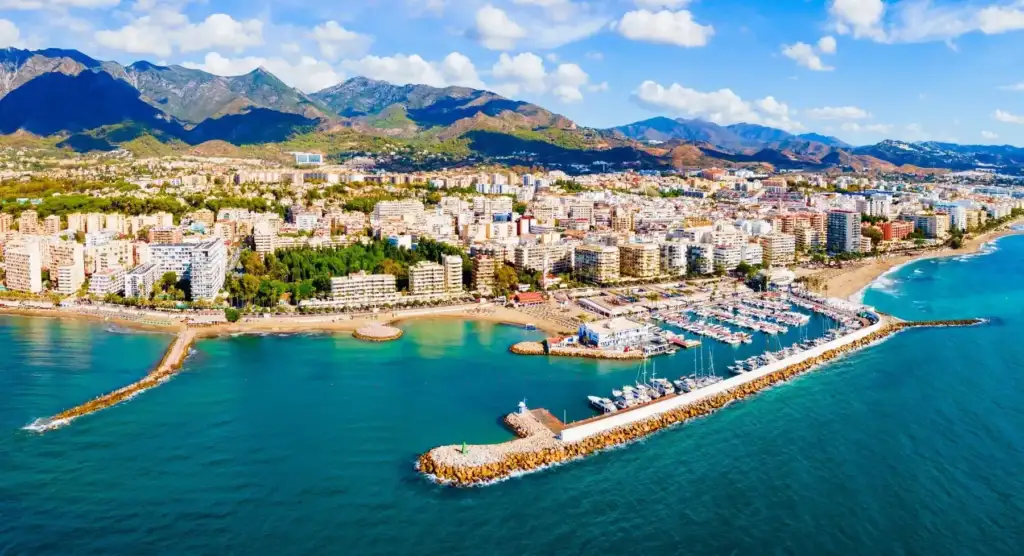 Coastal city with marina and mountains